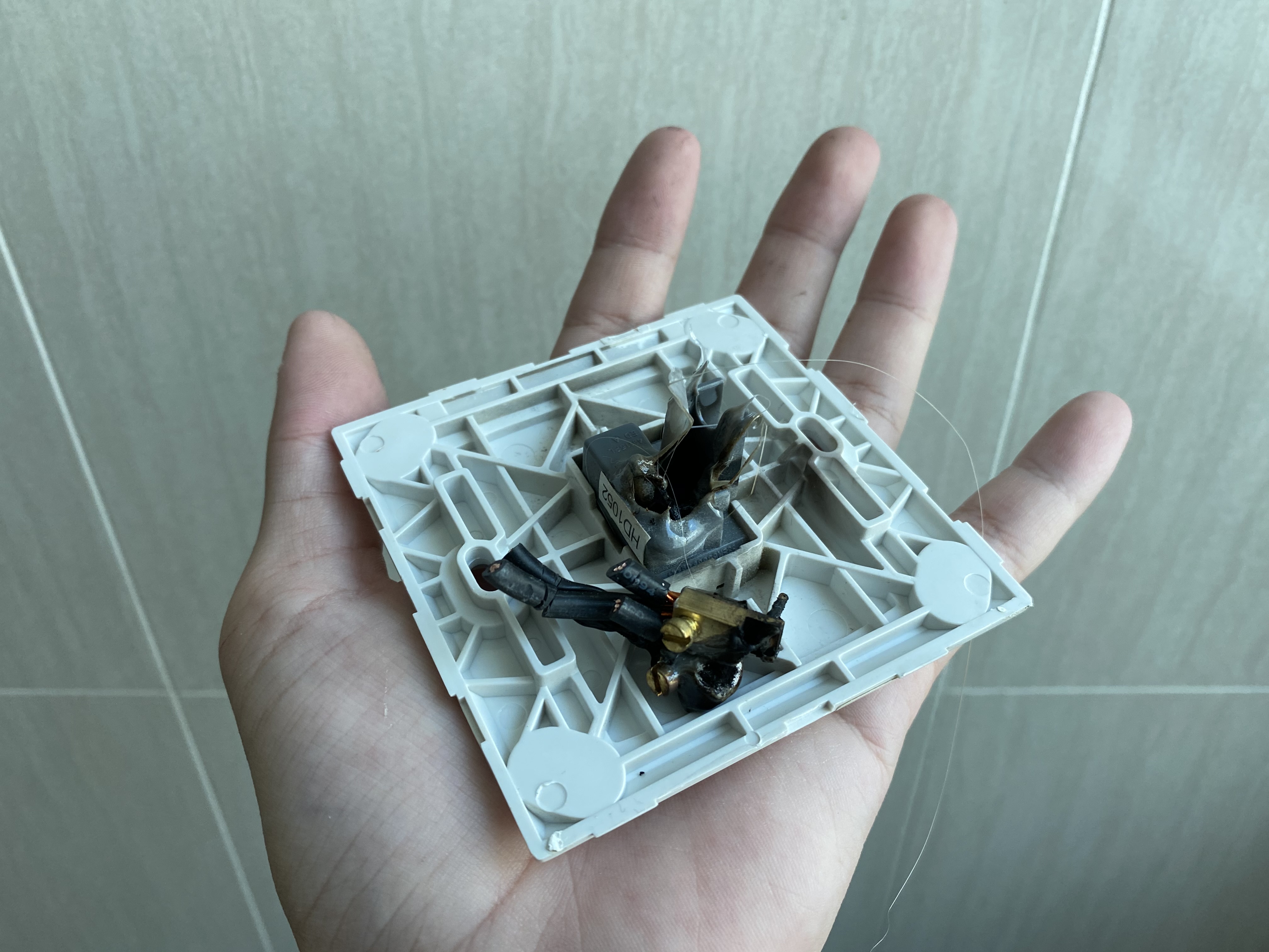 A switch with melted insulation and cables after it caught on fire
