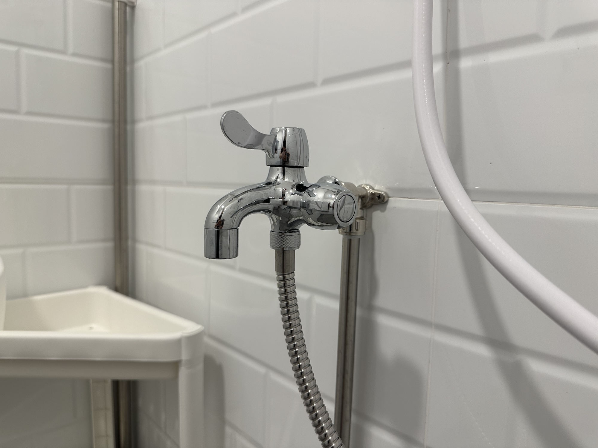 Image of a double tap installed on exposed stainless steel water pipes